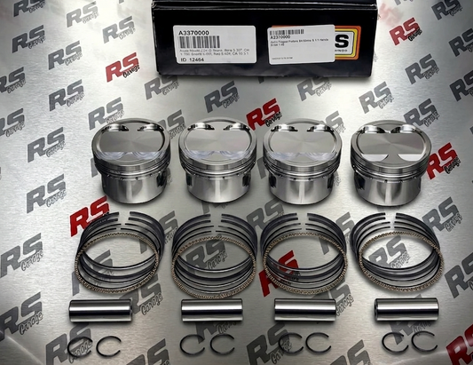 Set of piston rings and pins on a branded background